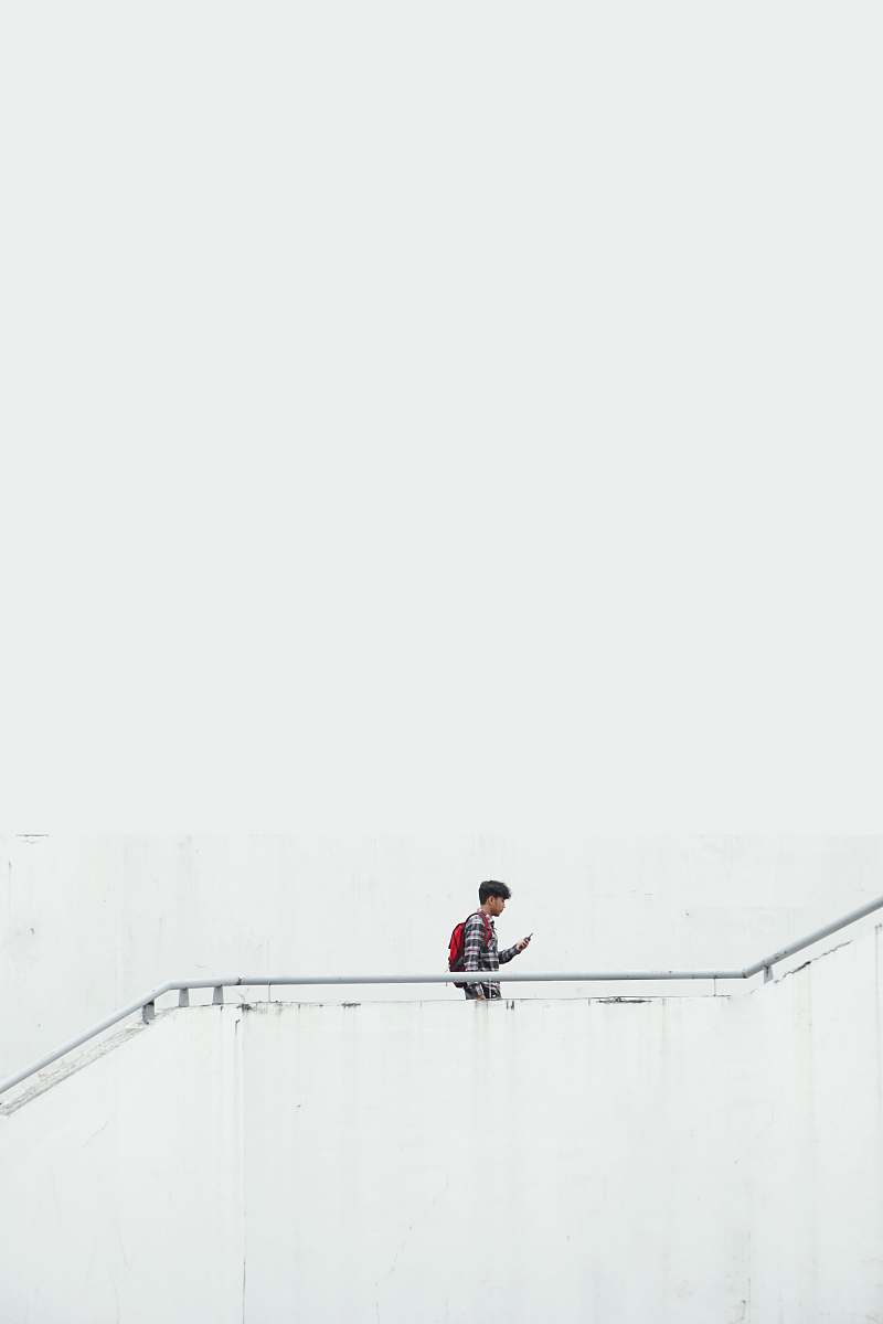 itb international relation office man on stair wearing red backpack indonesia